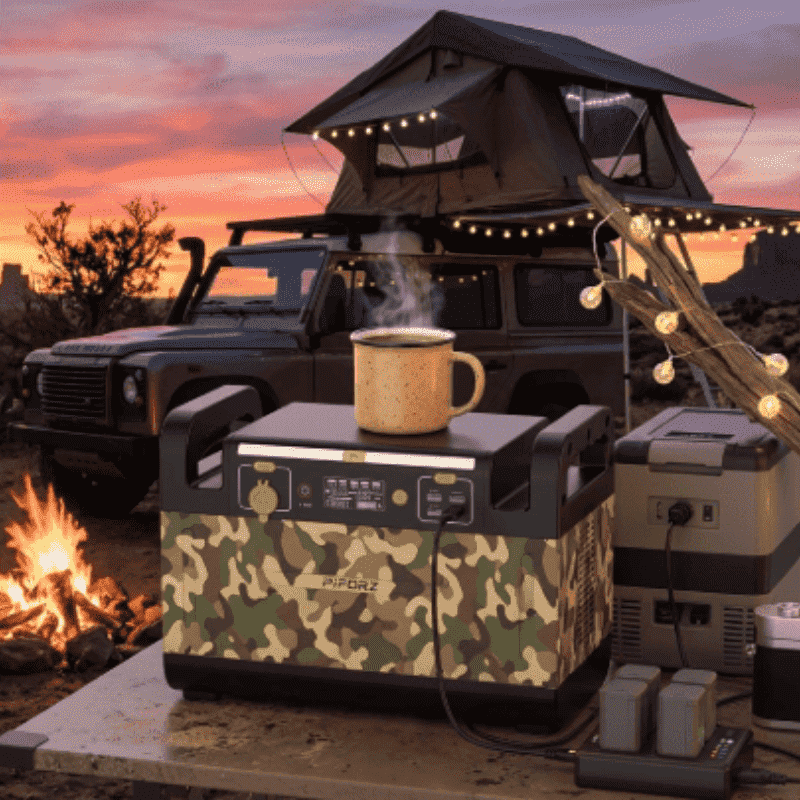 Piforz PF1500 overland power station with LiFePO4 battery powering a fridge and drone at a desert campsite, featuring shock-resistant construction for extreme off-road survival.
