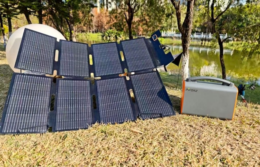 Foldable solar panels charging a Piforz portable power station beside a parked EV, creating a sustainable zero-emission energy loop for off-grid camping