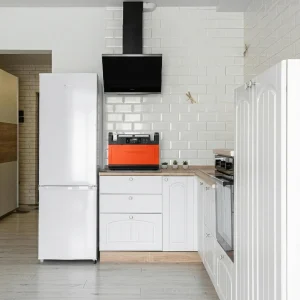 Large battery powered generator for refrigerator used as home backup power during outages in a modern kitchen.