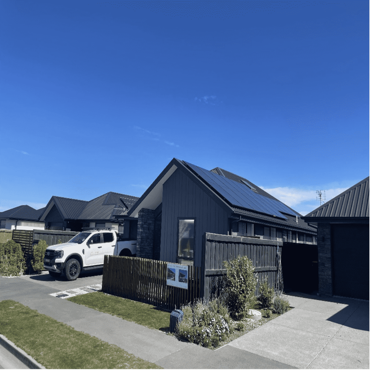 A modern smart home featuring a complete DIY solar kit with roof panels, showcasing aesthetic architecture and efficient off-grid energy integration.