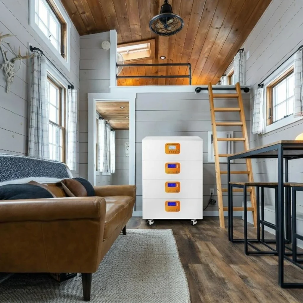 Large home battery energy storage system installed inside a modern tiny house for off-grid and backup power.