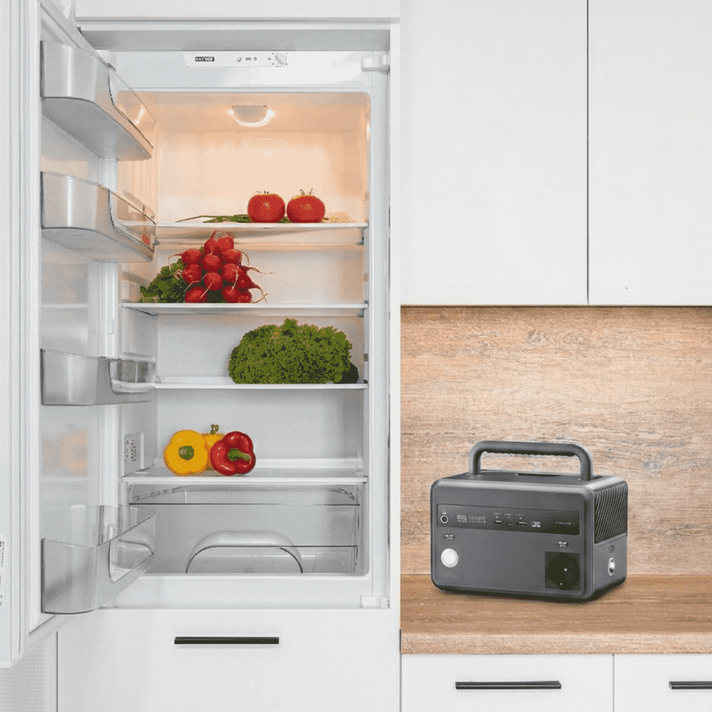 Portable battery generator powering an open refrigerator to keep food fresh during a power outage.
