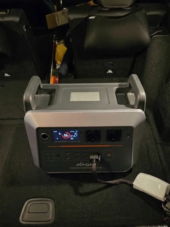 Charging a portable power station using a vehicle's cigarette lighter socket.