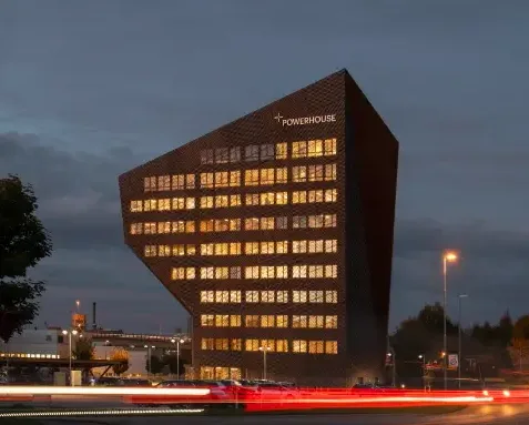 The angular facade of the Powerhouse Telemark building covered in photovoltaic panels.