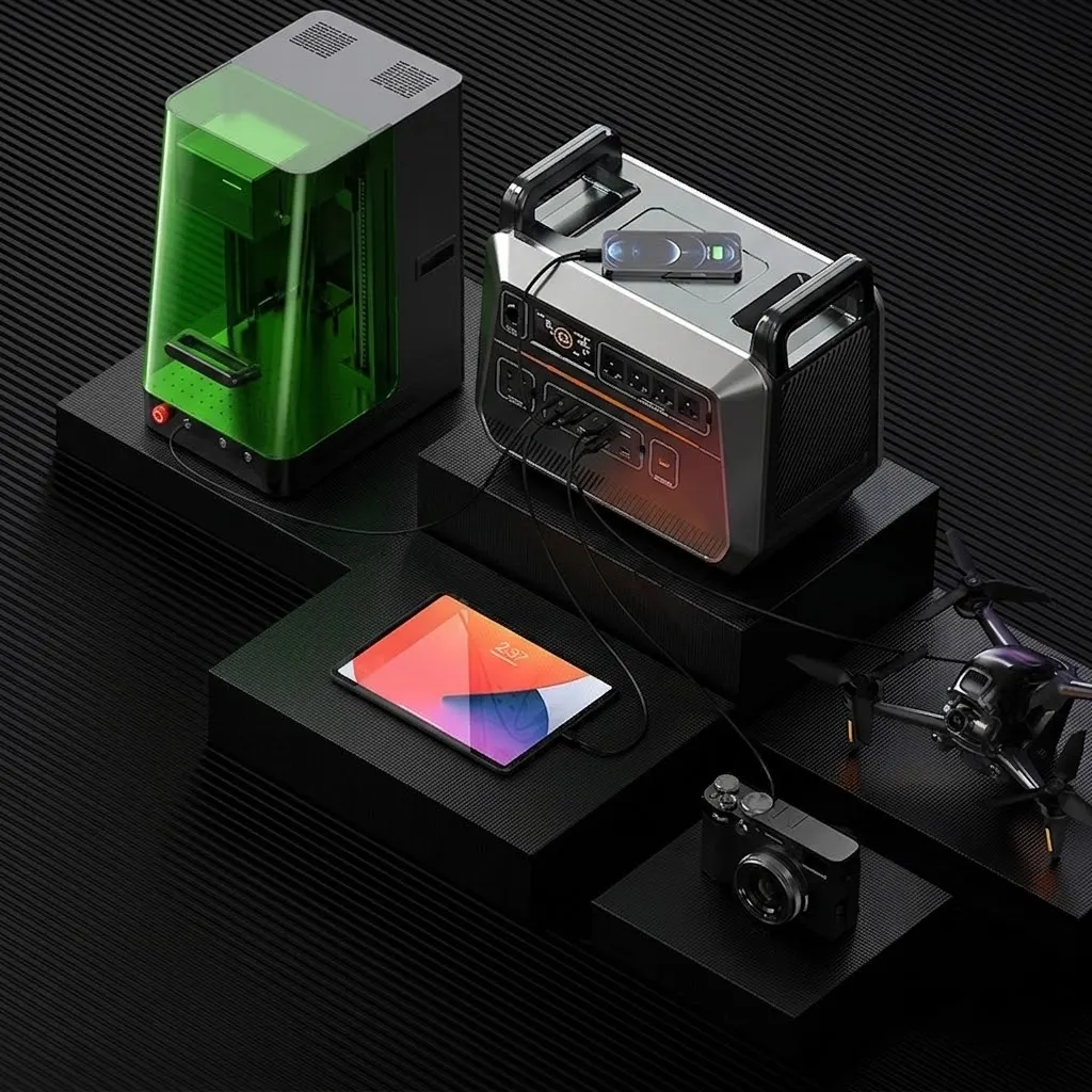 A modern portable power station with digital display and multiple AC ports connected to precision electronics.