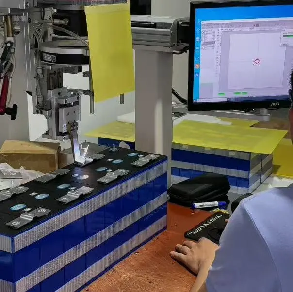 Robotic welding and computer-monitored testing equipment assembling LiFePO4 battery packs in a factory.